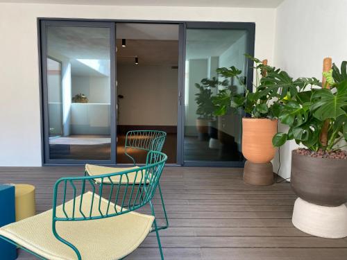 a lobby with two chairs and potted plants at Onix Fira in Barcelona