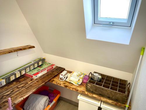 a room with a wooden shelf and a window at Fewo Linz in Frensdorf
