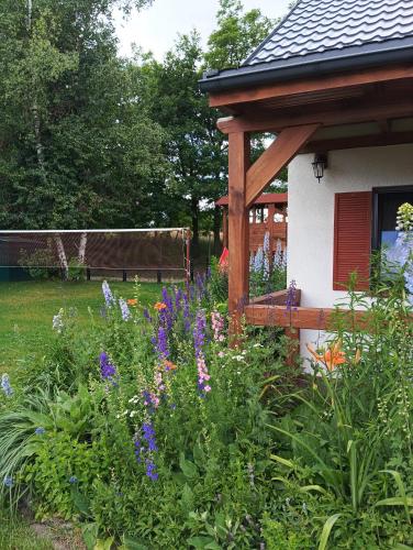 a garden with purple flowers and a gazebo at Smocze Ranczo 2 in Ośno Lubuskie