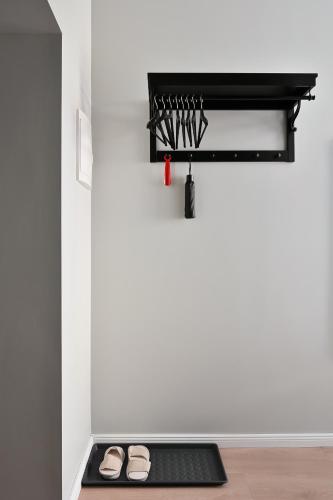 a room with a black shelf and shoes on a floor at Historical House Apartments in Rīga