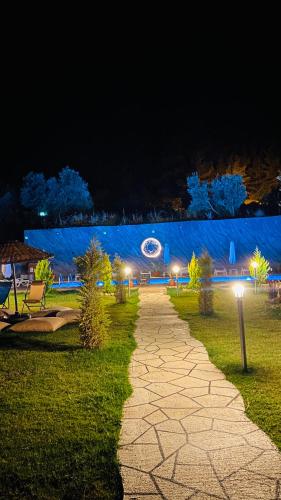 a walkway in a park at night at Karaöz Sapphire Bungalows in Kumluca