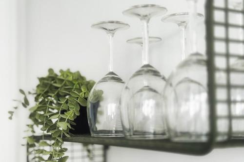 a shelf with glasses and a potted plant on it at #HZ Le bel Hugo Spacieux T5 Eybens in Eybens
