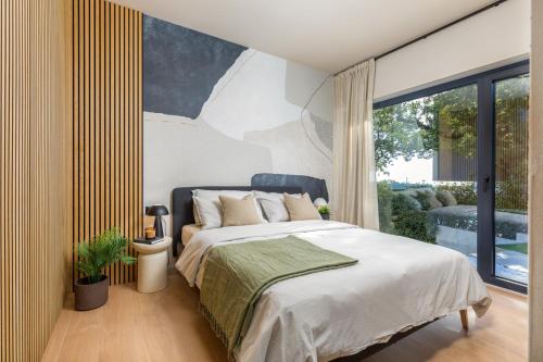 a bedroom with a bed and a large window at Villa Mol by Villsy - with private pool, sauna, jacuzzi in Baderna