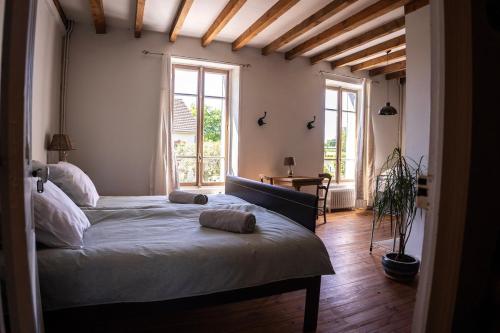 Ένα ή περισσότερα κρεβάτια σε δωμάτιο στο Le Cœur d'Estourgie