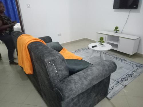 a living room with a couch and a table at Garden court in Lukenya