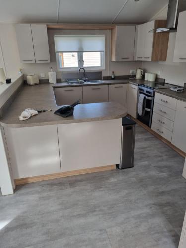 a kitchen with white cabinets and a counter top at Lakeside Lodge in Dunbar