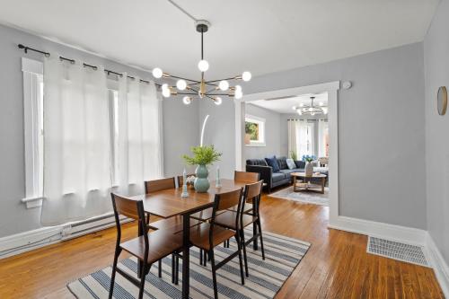 a dining room and living room with a table and chairs at Newly Renovated 2BR by SU, Zoo, Destiny & Downtown in Syracuse