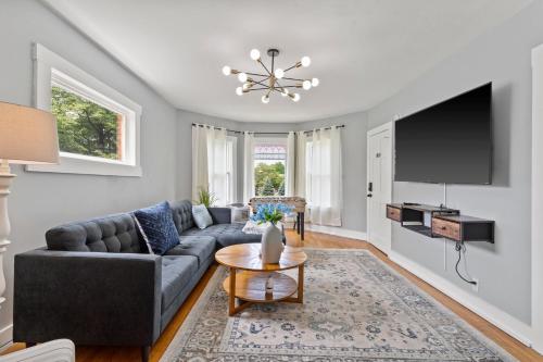 a living room with a couch and a tv at Newly Renovated 2BR by SU, Zoo, Destiny & Downtown in Syracuse