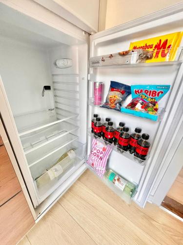 an open refrigerator filled with food and drinks at VB Central Apartment in Vejle
