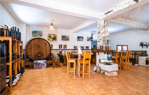 a wine tasting room with wooden tables and chairs at Lovely Apartment In Ponikve in Metohija