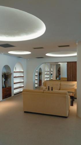a living room with couches and tables in a building at La Grotta in Volimes