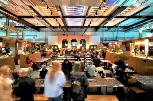 a crowd of people sitting at tables in a restaurant at 4A City Cottages in Chester