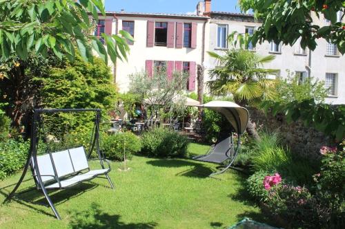 a swing in a garden with a building at Maison Prades Chambre d'Hôtes in Prades