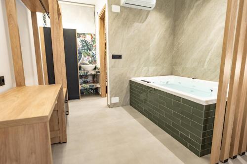 a bathroom with a tub and a sink at Elite Luxury Suites Bali Rethymno in Balíon