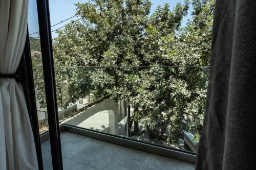 a view of a tree from a window at Elite Luxury Suites Bali Rethymno in Balíon