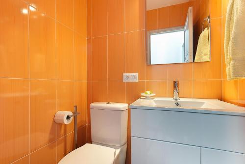a bathroom with a toilet and a sink and a mirror at Gruat 31 - Vallem Properties in Pollença