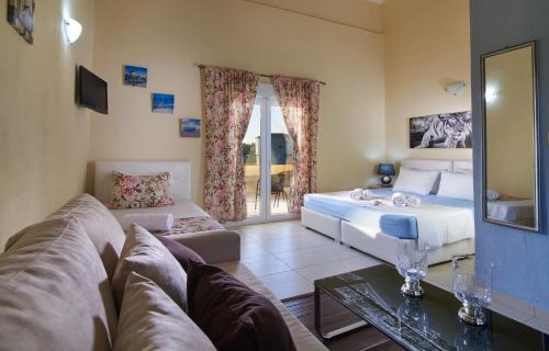 a living room with a bed and a couch at Caretta Village in Toroni