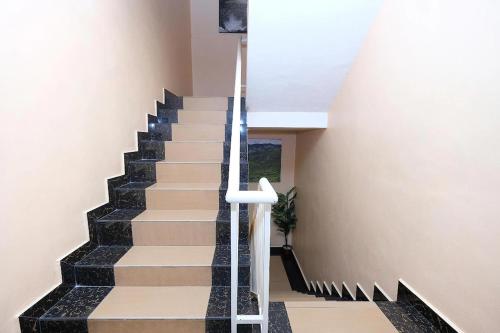 a staircase in a house with black and white stairs at Heaven Mountain Hill 2 Cameron Highlands in Cameron Highlands