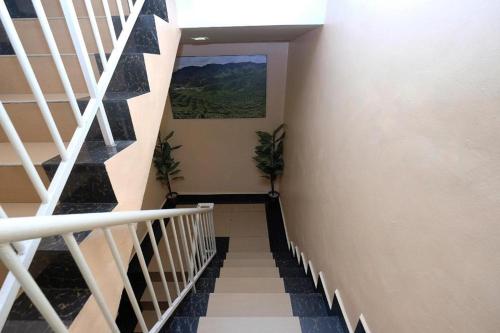 a staircase in a house with a painting on the wall at Heaven Mountain Hill 2 Cameron Highlands in Cameron Highlands