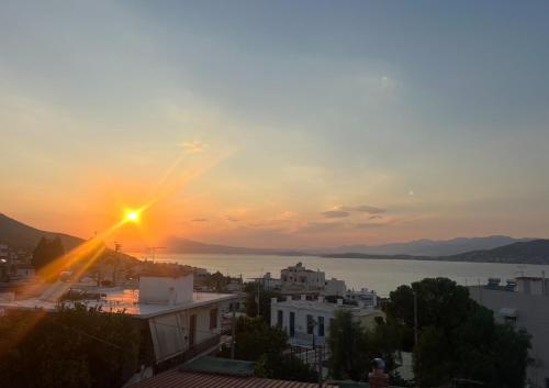 a view of the sun setting over a city at The White House - Aianteio in Aiándion