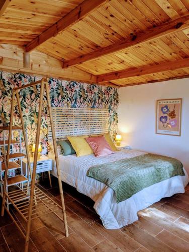 a bedroom with a bed and a wooden ceiling at Gaviota Beach Chiclana in Chiclana de la Frontera
