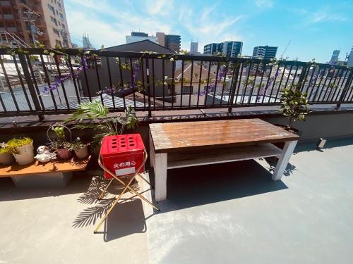 a wooden bench sitting on top of a balcony at MINPAKUx櫻花 in Osaka