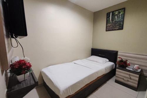 a small bedroom with a bed and a television at Heaven Mountain Hill 2 Cameron Highlands in Cameron Highlands