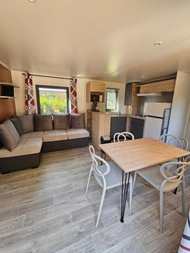 a living room with a couch and a table at Camping de Charlieu in Charlieu