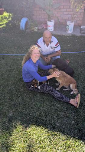 a man and a woman sitting on the grass with a dog at LA CASA DE RICKY "El balcón de las Montañas" in Caraz