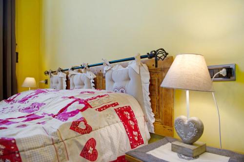 a bedroom with a bed and a lamp on a table at Arthemisia - Rhêmes-Notre-Dame in Rhêmes-Notre-Dame