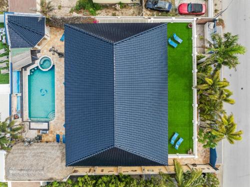 an overhead view of a tall building with a pool at La Casa Piu Bella where the customer is king in Palm-Eagle Beach