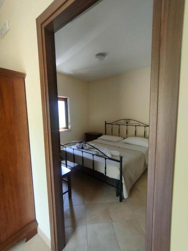 a bedroom with a bed and a large mirror at La Locanda del Mugnaio in Roseto Valfortore