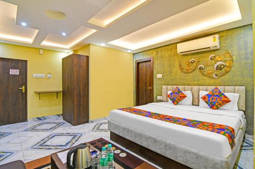 a bedroom with a large bed in a room at FabHotel The Crown - Near Star Mall in Kolkata