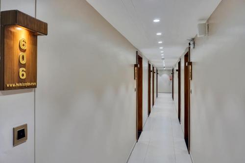 an empty corridor of a hospital with a row of halls at Hotel Sayba International in Pune