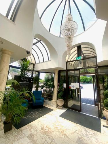 a lobby of a building with a chandelier at Durrant House Hotel in Bideford