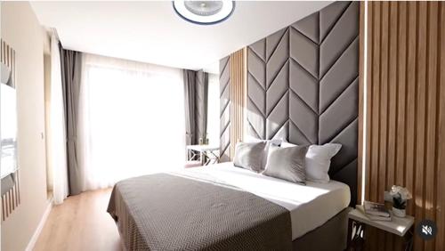 a bedroom with a large bed and a large window at Harmony Suites Grand Resort 16 in Sunny Beach