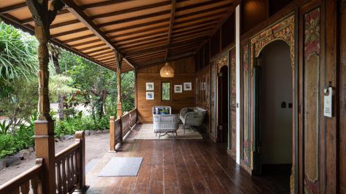 a porch of a house with a wooden ceiling at Plataran Komodo Resort & Spa - CHSE Certified in Labuan Bajo