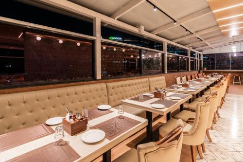 a long dining room with tables and chairs at TGI Livancia The Sojourn in Bengaluru