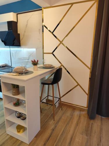 a desk and a chair in a room with a wall at Apartman Aleksije in Igalo