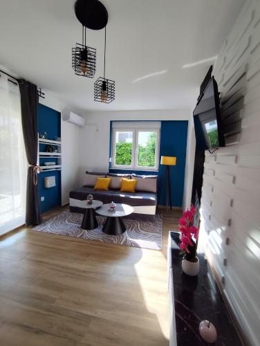 a living room with a couch and a tv at Apartman Aleksije in Igalo
