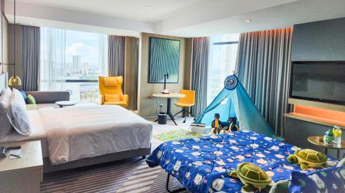 a bedroom with a bed and a play tent at Holiday Inn Johor Bahru City Centre by IHG in Johor Bahru