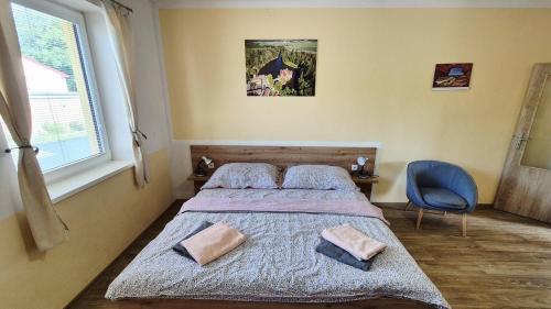 a bedroom with a bed with two pillows on it at Penzion a restaurace Zlatovláska u zámku Červená Lhota in Jižná