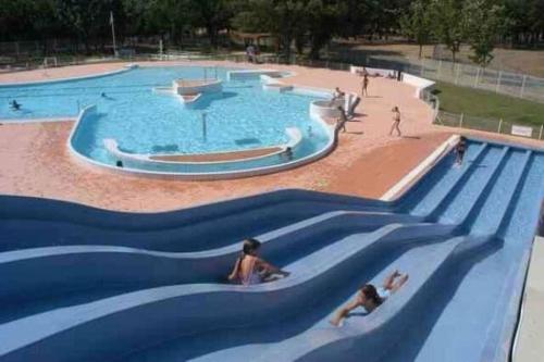 a group of people swimming in a swimming pool at Cozy apartment in Château-Arnoux-Saint-Auban
