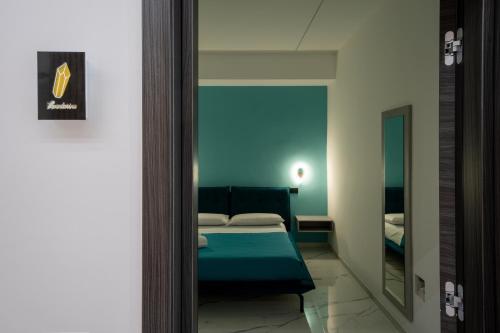 a bedroom with a bed and a mirror at CrystalRooms in Leverano