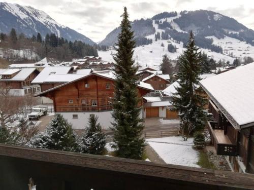 a view of a ski lodge with snow covered mountains at Central Location Cozy 3 BR Flat in Gstaad in Gstaad
