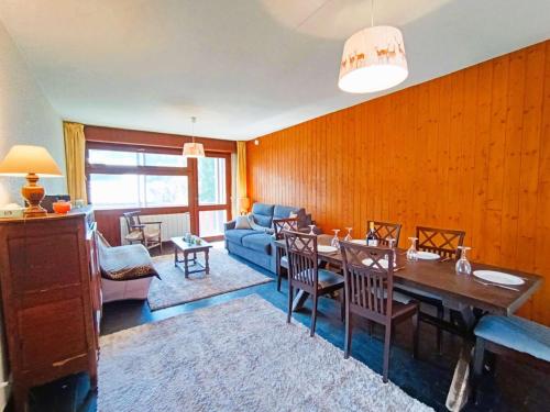 un salon avec une table et un canapé bleu dans l'établissement Appart T2 pour 6 pers. à Saint-Lary-Soulan - FR-1-457-381, à Saint-Lary-Soulan