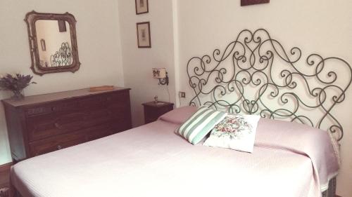 a bedroom with a white bed and a mirror at Belvedere 10 in Pietrasanta