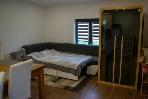 a living room with a bed and a couch at Apartman Zara in Krapina