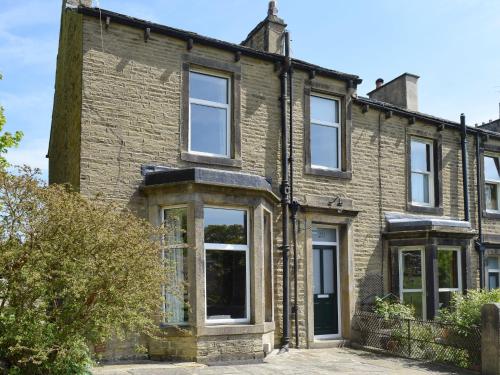 an old brick house with white windows at Ash Grove in Skipton