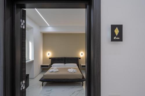 a bedroom with a bed through a doorway at CrystalRooms in Leverano